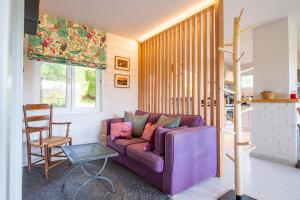 瑟穆瓦河畔夫雷斯Le Chalet的客厅配有紫色沙发和椅子