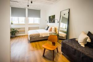 特拉维夫Gia home的一间卧室配有一张床、一张沙发和一面镜子