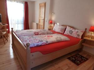 巴特迪克海姆Pfälzer Landhotel Heinrich的一间卧室配有一张红色棉被的床