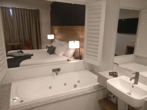 纽卡斯尔Springs Newcastle的带浴缸、床和盥洗盆的浴室