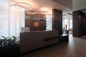 波代诺内桑丁酒店的一个带前台和盆栽植物的办公大厅