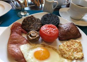 BowmoreAn Cuan Bed & Breakfast的包括鸡蛋培根和西红柿的早餐食品