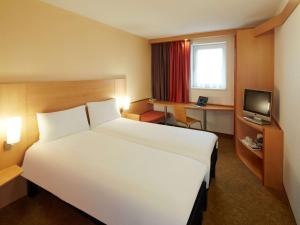 雷丁ibis Reading Centre的酒店客房设有一张白色大床和一台电视。