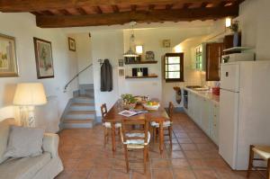 RoccalbegnaPera的厨房以及带桌子和沙发的客厅。