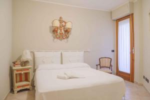 波吉邦西Apartment in Poggibonsi/Toskana 38410的白色卧室配有白色的床和吊灯