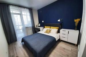 伊尔平Relax Point Plus Apartment的一间卧室设有一张床和蓝色的墙壁