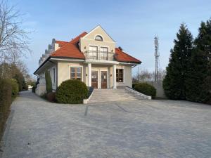 琴斯托霍瓦Zielony Dworek的车道上带红色屋顶的白色房子
