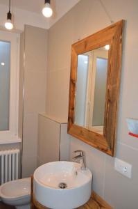 梅佐拉戈Apartments in Pur/Ledrosee 22640的一间带水槽、镜子和卫生间的浴室