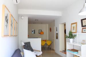 福恩吉罗拉Apartamento Fuengirola Centro的客厅拥有白色的墙壁和黄色的椅子