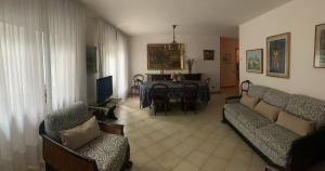 罗韦雷托Casa Betulla的带沙发的客厅和用餐室