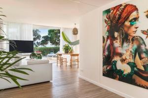 圣埃乌拉利亚ME Ibiza - The Leading Hotels of the World的客厅的墙上挂着一幅大画