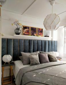 普特拉贾亚Maya Homestay Putrajaya @ Twelve的一间卧室配有一张大床和蓝色床头板