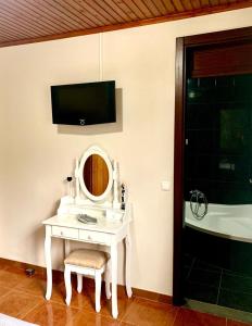 Santo AmaroNinho das Cagarras的浴室设有白色梳妆台、镜子和浴缸