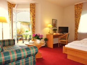 勒伯尔姆利兹加尼乡村酒店的配有一张床和一张书桌的酒店客房