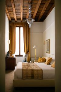 威尼斯圣乔治住宿加早餐旅馆的一间卧室配有一张大床和一个吊灯。