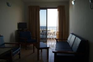 拉雷斯廷加Apartamentos Los Saltos的带沙发的客厅,享有海景