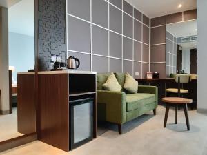 茂物Swiss-Belinn Bogor的客厅配有绿色沙发和桌子