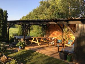 BeekdorpHoliday Home in Reutum Weerselo with Jacuzzi的花园内带野餐桌的木制凉亭