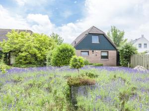 WolphaartsdijkLovely holiday home in Wolphaartsdijk的一座房子前面的紫色花田