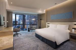 南京南京喜玛拉雅假日酒店的酒店客房设有一张床和一个大窗户