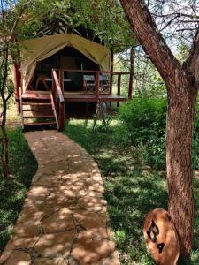 KajiadoOldonyo Orok Lodge的凉亭,配有桌子和树