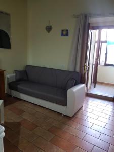 斯波莱托Appartamento via della Posterna Spoletium的沙发坐在客厅隔壁的门