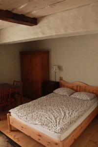 厄尔科Pensjonat Stary Spichlerz的卧室内的一张床铺,配有木制床架