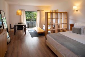 卡斯卡伊斯维拉比库达度假酒店的一间卧室配有一张床、一张桌子和一张桌子