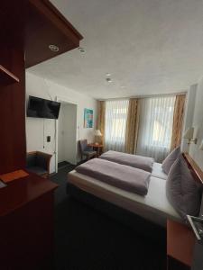 克洛滕Cafe Moselterrasse的酒店客房设有一张大床和一台电视。