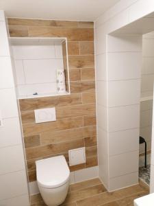 阿尔滕堡Kunstgasse 4+5的浴室配有白色卫生间和木墙