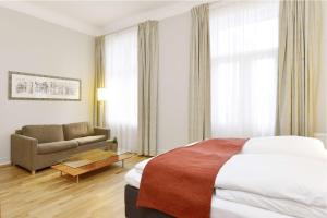 奥斯陆霍尔伯格斯堪迪克酒店的酒店客房,配有床和沙发