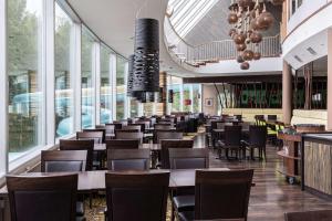 诺基亚诺基亚斯堪的克艾登酒店的用餐室设有桌椅和窗户。