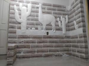 乌尤尼Hotel Kachi de Uyuni的砖墙,上面有动物雕塑