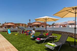 科斯塔德安提瓜Perfect for family holidays with private pool, near beach and golf- Villa Ashley的一个带桌椅和遮阳伞的庭院