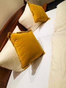 HorstmarDa‘ Amici的床上的2个枕头和黄色枕头