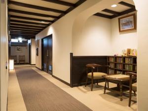 高山阿苏娜若日式旅馆的走廊上设有藏书丰富的桌椅
