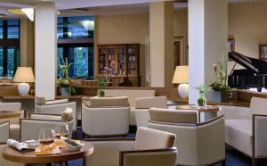 蒙特格罗托泰梅泰尔梅花园酒店的酒店大堂设有桌椅和钢琴
