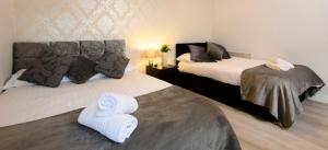 利物浦The Eaton的酒店客房,配有两张带毛巾的床