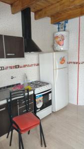 马拉圭MALARGUE STYLE,A 100 Mtrs DEL CENTRO,MUY UBICADO的厨房配有炉灶和白色冰箱。