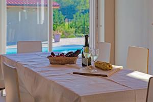 LaurianoAgriturismo Casa Matilde的一张桌子,上面放着一瓶葡萄酒和一篮子的食物