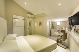 索伦托马吉雷莱斯酒店的卧室配有白色的床和书桌