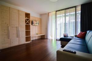 特伦托Komodo short stay apartments的带沙发和大窗户的客厅