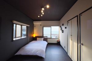 明石市Awaji Aquamarine Resort #1 - Self Check-In Only的卧室配有白色的床和窗户。