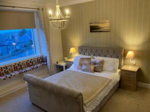 柯克沃尔Shorelands B&B的一间卧室设有一张大床和一个窗户。