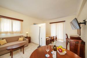 Ágios IoánnisAqualand Resort的客厅配有沙发和桌子
