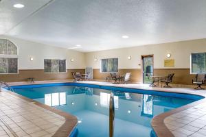 卡斯特Comfort Inn & Suites Near Custer State Park and Mt Rushmore的一座配有桌椅的酒店游泳池