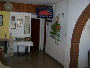 维拉卡洛斯帕兹阿罗哈宾馆的一间房间,墙上设有一张桌子和一台电视机
