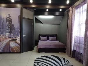 伊热夫斯克奥斯汀洛夫酒店的一间卧室,配有一张床,并享有城市的图片