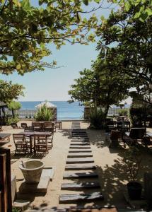 阿鲁甘湾维斯塔湾酒店的一个带桌椅的庭院和大海