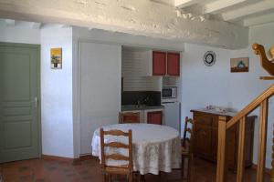 Saint-Ouen-des-ToitsChambre d hote La Roussiere的一间带桌子的厨房和一间带桌椅的厨房